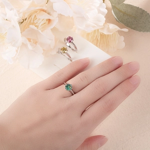 Detailed view of 1-carat moissanite rings in green and yellow with 6-prong silver setting