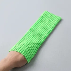 Close-up of neon green ribbed knit leg warmer showing high-elasticity texture