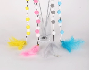 Detail of colorful pet cat teaser sticks with plush balls and soft natural feathers