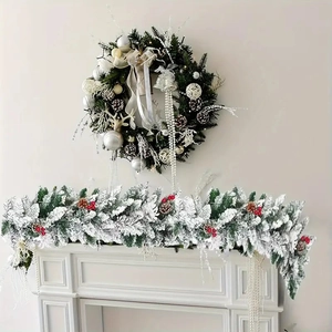 Detail view of snowy Christmas garland and wreath with silver ornaments on a white fireplace