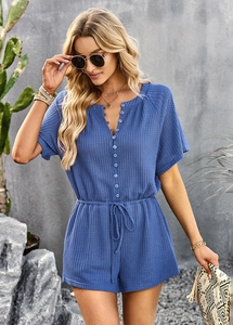 Detailed texture of blue waffle knit fabric on a women's V-neck casual short romper
