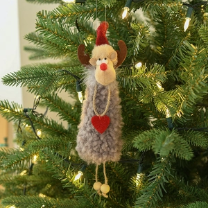 Plush Christmas reindeer ornament hanging on a festive tree with warm lighting