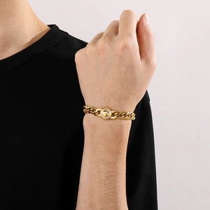 Macro shot of gold cuban link bracelet with a sparkling diamond-encrusted round clasp