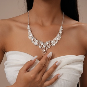 Close-up of a sparkling V-shaped rhinestone necklace with pear and teardrop crystals