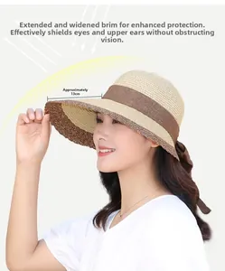 Detail of summer straw hat with 13cm wide brim, beige-brown patchwork and bow decoration