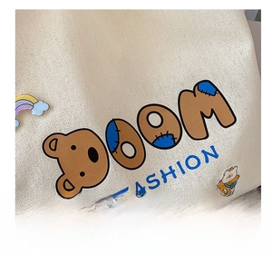 Detail eines hochwertigen Bärendrucks auf beiger Canvas-Tasche mit Modetext