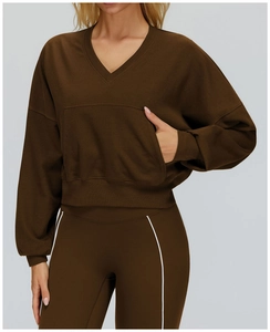 Detail of dark brown V-neck hooded sweatshirt with front pocket and ribbed texture