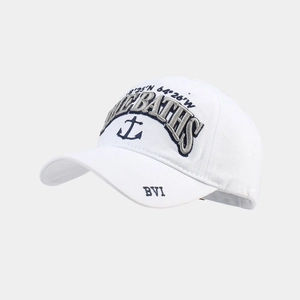 Detail of white cotton baseball cap featuring 3D embroidery with nautical anchors and coordinates