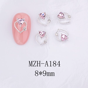 Detail of silver heart nail charms with pink crystal and tiny rhinestones for manicure