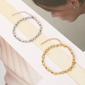 Detail of gold and silver pig nose chain bracelets with inlaid white zircon stones