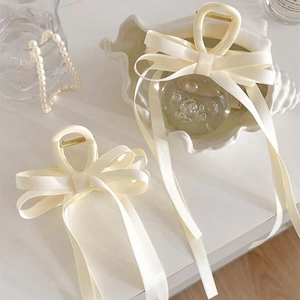 Elegant cream white satin ribbon bow hair claw clip for a French minimalist style