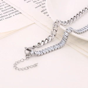 Detail of silver Cuban link necklace and rectangular zircon chain with lobster clasp