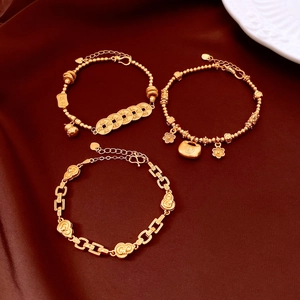 Detailed view of 24K gold plated bracelets with traditional Chinese lucky charms