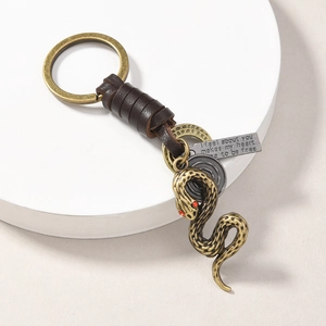 Detail of vintage anchor keychain with brown leather wrap and engraved quote tag