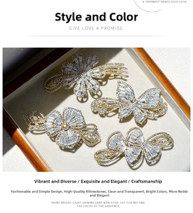 Detailed view of four zircon and crystal butterfly hair clips in a grey velvet jewelry box