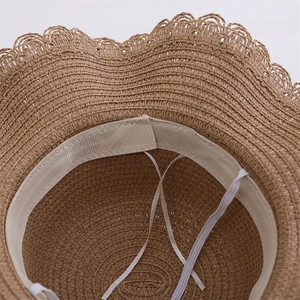 Close-up of children straw hat inner lining with adjustable drawstring and sweatband