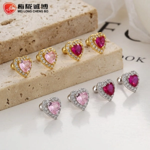 Close-up of heart-shaped pink zircon earrings with silver and gold screw-back studs