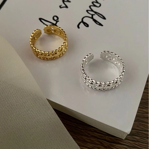 Detailed close-up of S925 sterling silver beaded rings in gold and silver finishes