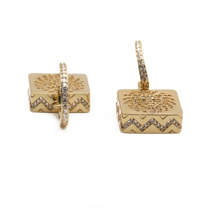 Golden lion head earrings with micro-paved zircons and wavy edges on white background