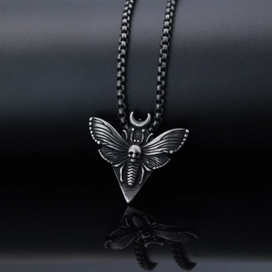 Detail of gothic moth and skull pendant with crescent moon in antique silver finish