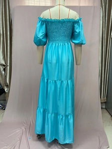 Detail of light blue off-shoulder dress featuring tiered layering and elastic bust texture
