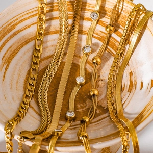 Golden multi-layer layered chain necklaces featuring snake and curb links with zircons