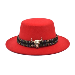 Flat top red wool felt hat featuring ethnic woven band and vintage metal bull head accent