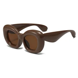 Modern chunky dark brown sunglasses with bubble style frame on white background