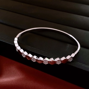 Close-up of silver hexagon honeycomb bracelet featuring pavé-set zircons and hinged clasp