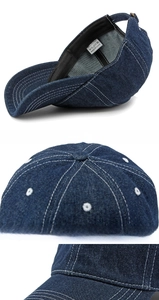 Detail of dark blue denim baseball cap featuring white contrast stitching and cotton fabric