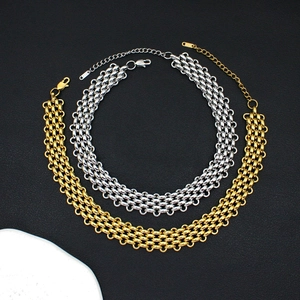 Close-up of gold and silver multi-layer woven chunky chain necklaces with lobster clasps
