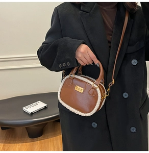 Detail of plush pillow bag with brown PU leather and white faux fur held by a model