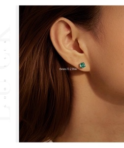 Detailed view of 6mm round Paraiba color green stud earrings in 925 sterling silver