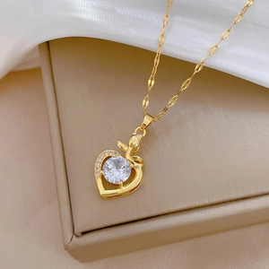 Luxurious gold heart pendant necklace with shimmering zircon stones on elegant gift box