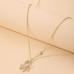 Macro view of gold unicorn necklace with sparkling pavé crystals and dainty chain