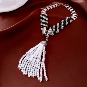 Vintage style beaded necklace with sparkling rhinestones and a large pearl tassel pendant
