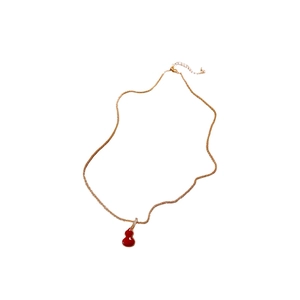 Gold plated necklace with a red double-sided wulu pendant and small crystal accents