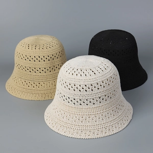 Detail of hollow-out crochet knit sun hats showing breathable texture and woven patterns