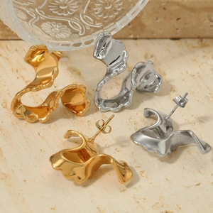 Minimalist geometric lava earrings in gold and silver finish on stone background