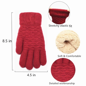 Detailed view of red knitted gloves showing thick fleece lining and elastic wrist measurements