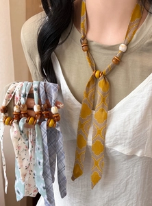 Detailed view of handmade chiffon printed tie necklaces with wood and acrylic beads