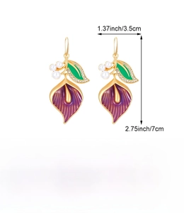 Detailed macro view showing calla lily enamel drop earrings with pearls and crystals