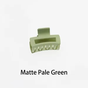 Detail of matte pale green hollow rectangular hair claw clip with a mini 4cm square design