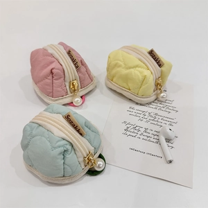 Quilted heart-pattern mini coin pouches in pastel pink, yellow, and mint green with pearl charm