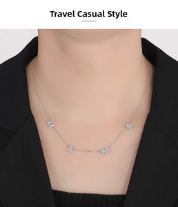 Close-up of S925 sterling silver MAMA letter pendant necklace with shimmering crystals