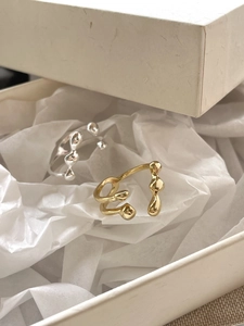 Macro shot of silver and gold irregular S925 sterling silver rings in gift box