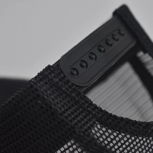 Detail of adjustable snapback closure on black mesh trucker hat with 7-hole plastic strap