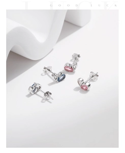 Macro view of S925 silver heart stud earrings with S925 hallmark and colorful stones