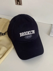Detailed close-up of Brooklyn 1947 3D embroidery on navy blue cotton baseball cap