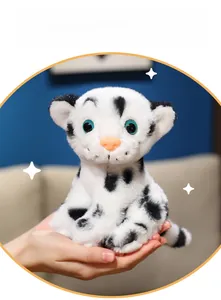 Close-up of cute white tiger plush toy with blue eyes and pink nose in hand